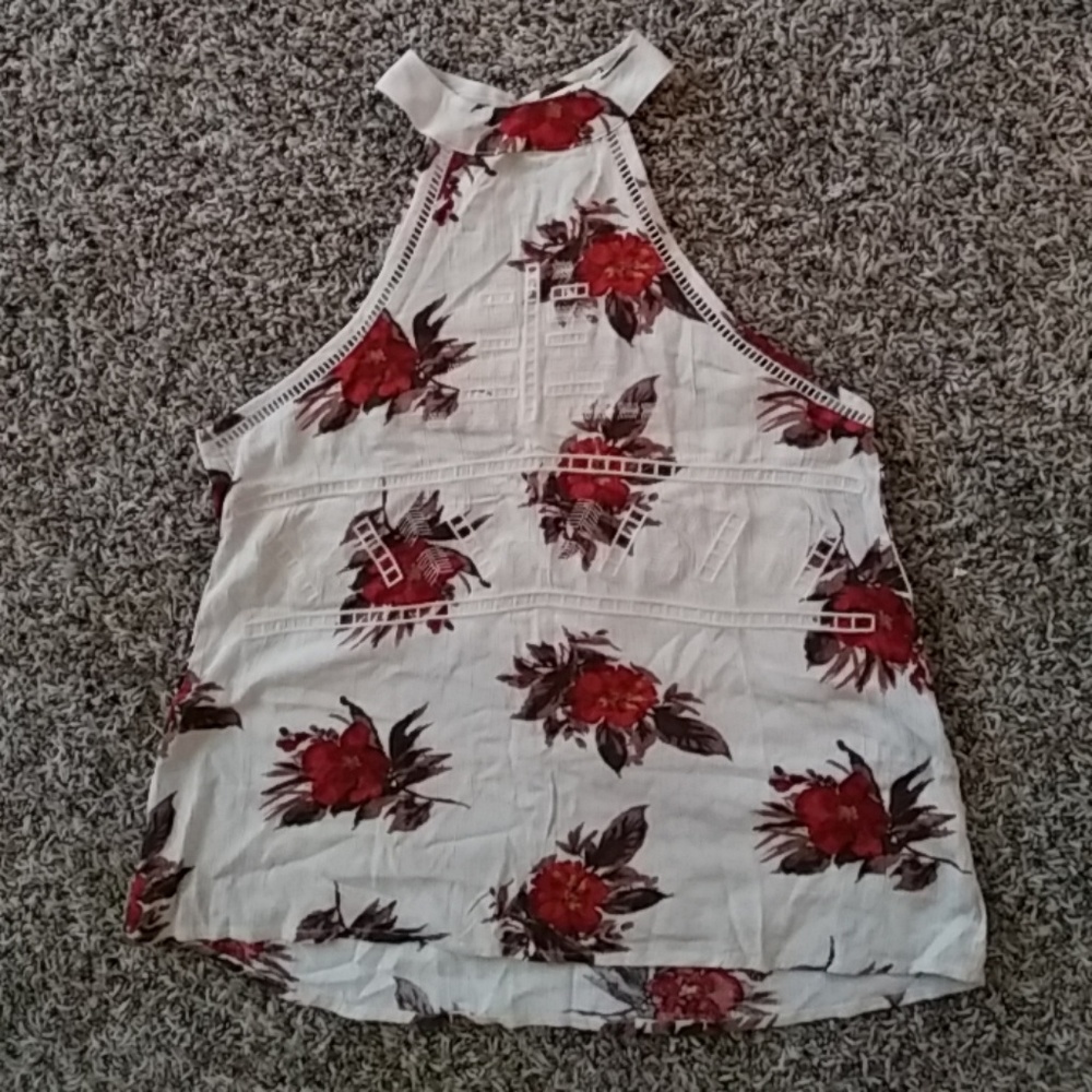 Tan sleeveless top that buttons around the neck